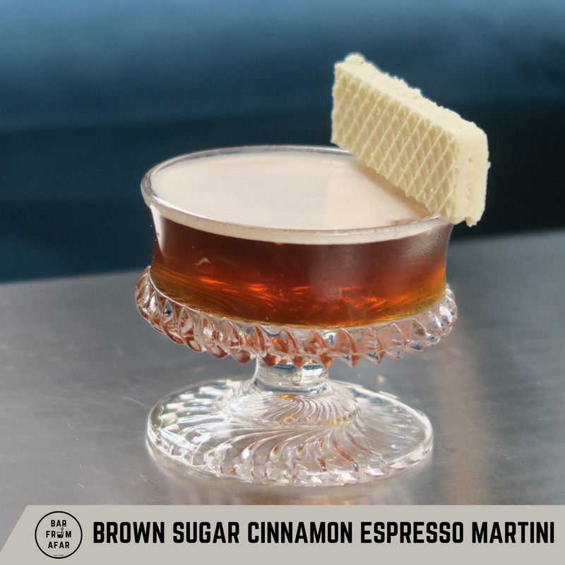 Cinnamon Brown Sugar Espresso Martini in a glass, with a vanilla wafer as the garnish 