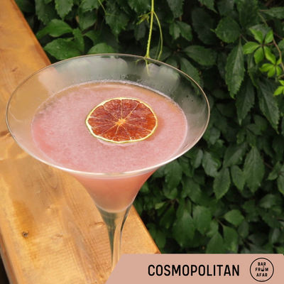 Cosmopolitan Cocktail, in a glass, garnished with a dried slice of grapefruit 