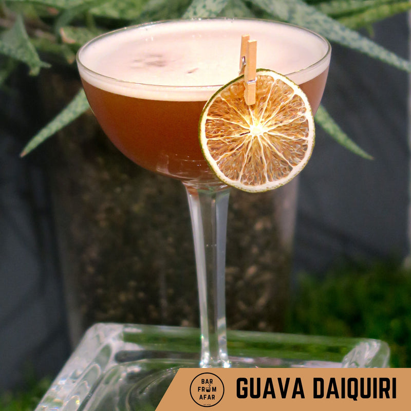 Guava Daiquiri cocktail in a glass with a dehydrated lime as a garnish 