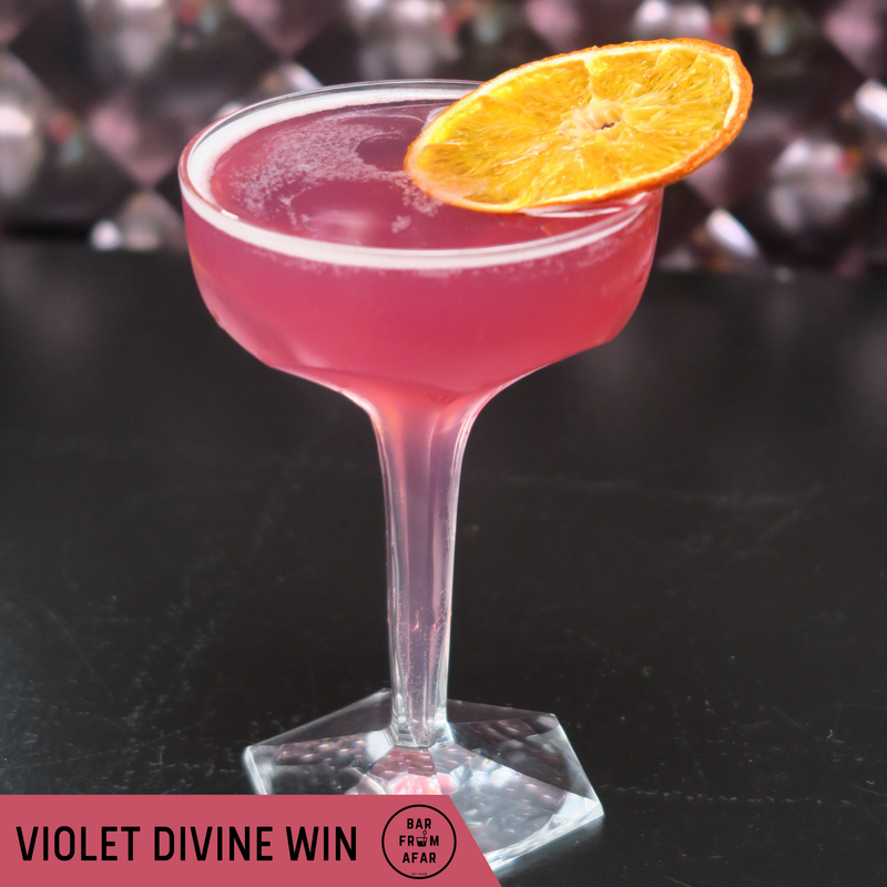 Violette Divine Wind cocktail in glass with dehydrated orange garnish 